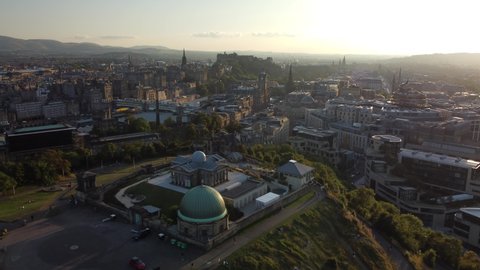 4K Aerial View of Edinburgh City Skyline, Castle, Observatory and Old Town taken by Drone from Calton Hill at Sunset (Scotland, UK)