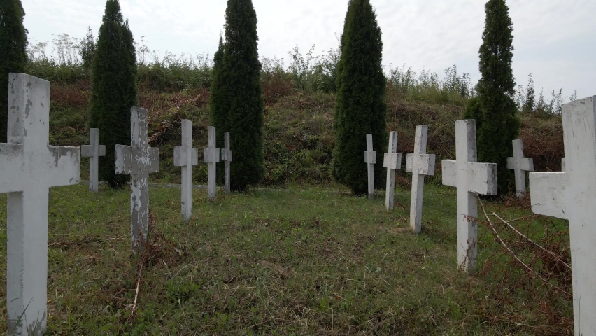 A row of graves of unknown soldiers killed in World War II. Row of white crosses