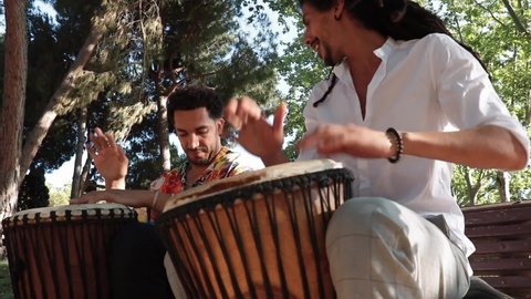 Barcelona, ​​Spain. 09-17-21: Photo of two young people playing the drum in the park.