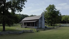 4K aerial of rustic log cabin surrounded by old wooden fence in rural south - Powered by Shutterstock - Get 15% off with code: PIKWIZARD15