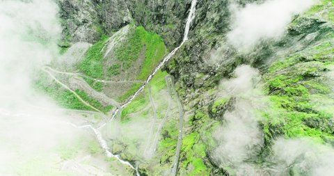 Hairpin turns on Trolls road in lush mountain hillside - aerial bird's-eye view