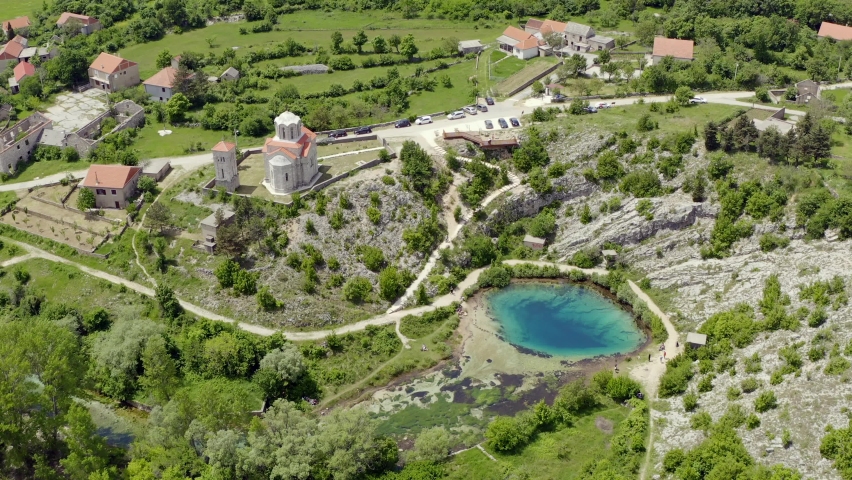 Aerial View Of Church, Cetina River Karstic Spring With Lush Green Vegetation In Summer. - pullback Royalty-Free Stock Footage #1079319161