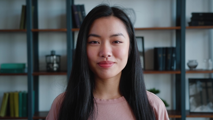 Close-up, face portrait of beautiful asian girl, lady, young woman looking at camera and smiling at modern office background | Shutterstock HD Video #1079320883