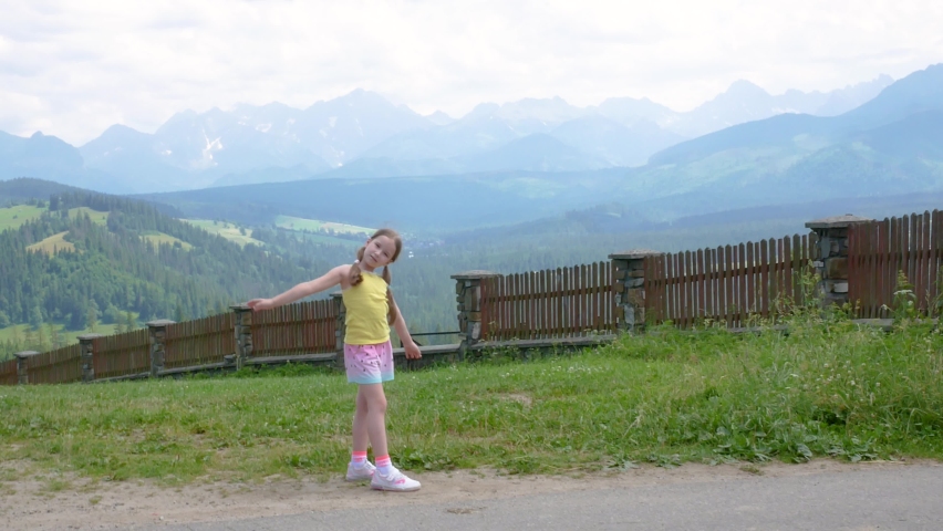 Little happy girl, young cheerful school age child on vacations, holidays, Tatra Polish mountains panorama, Europe Poland travel destinations concept, beautiful Tatras landscape, children travelling