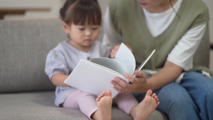 Parents and children reading picture books  Royalty-Free Stock Footage #1079324066