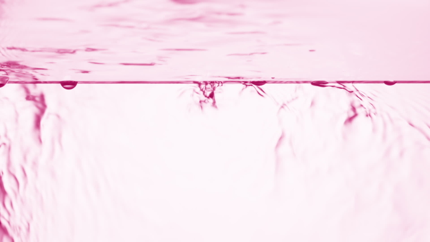 Pink fluid is flowing down from glass surface on pale pink background | Background shot for body care cosmetics advertising Royalty-Free Stock Footage #1079324789