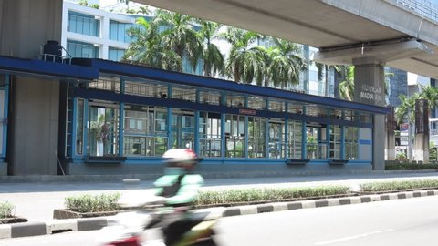 Jakarta, Indonesia - September 18 2021: Rasuna Said Street - Trans Jakarta Bus Arriving and Departing - at Kuningan Madya Aini Stop 