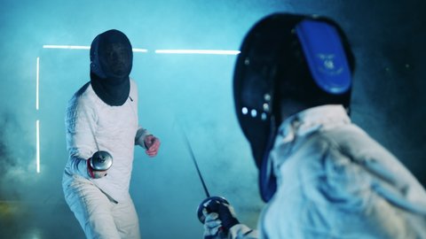 A fencer knocks a foil out of his opponent's hand