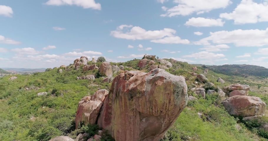 Large granite rock under blue sky