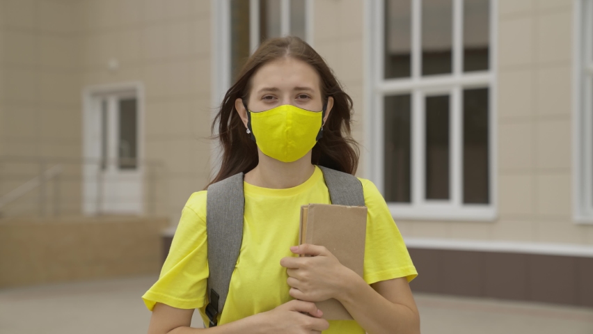Young girl schoolgirl smiling in a protective mask, coronavirus pandemic, covid 19, safe walking around the city, helps from infections and dust, air filtration, keep healthy people safe, concept Royalty-Free Stock Footage #1079349476