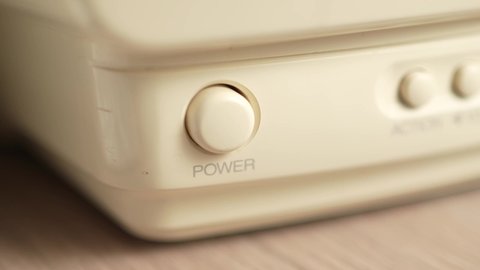 Pressing the power button of a white device to turn it on