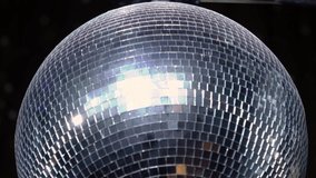 The disco ball is spinning at the party. Light effects of the starry sky, reflections in a mirror ball. Stage light in a nightclub or concert. Blue and white. - Powered by Shutterstock - Get 15% off with code: PIKWIZARD15