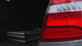 The worker puts the box of frozen meat in the trunk of the car. 4k video