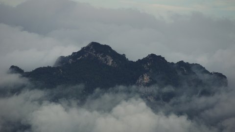 Time lapse, Beautiful Landscape in the morning time during sunrise with fog above the mountain, White fluffy clouds moving softly on cloudy, Pang puay, Mae moh, Lampang, Thailand.