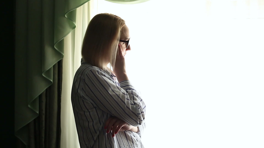 Sad Woman looks out the window | Shutterstock HD Video #1079357276