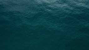 Nature video Aerial view of disturbed blue ocean water surface. 4K 10bit 4:2:2
