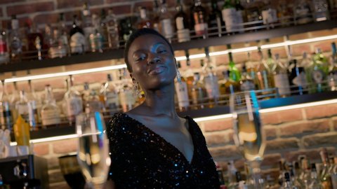 Stylish Black Girl Dancing At Bar. Smiling Girl With Short Hair And Big Earrings.