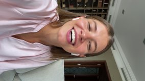 Vertical mobile cam view cute smiling young lady student in wireless headset hold phone shoot self video for social media chat by videocall. Teen female vlogger influencer stream online on web channel - Powered by Shutterstock - Get 15% off with code: PIKWIZARD15