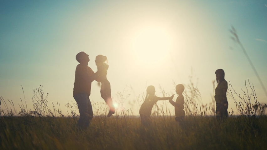 people in the park. happy family playing in the park silhouette. father throws up playing with daughter. happy family kid dream concept. friendly fun family in the park playing picnic Royalty-Free Stock Footage #1079388329