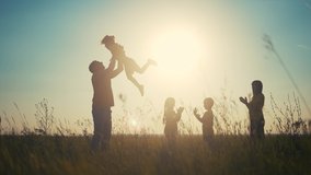 people in the park. happy family playing in the park silhouette. father throws up playing with daughter. happy family kid dream concept. friendly fun family in the park playing picnic - Powered by Shutterstock - Get 15% off with code: PIKWIZARD15