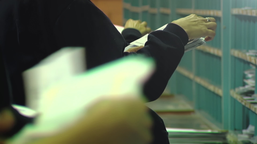 Hands of Postal Workers Sorting Mail at Post Office. Close Up. Royalty-Free Stock Footage #1079390204
