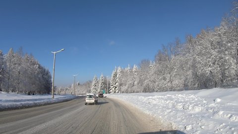 NOVOSIBIRSK, RUSSIA - FEBRUARY 12, 2020: Novosibirsk Academgorodok in winter. Driving on a snowy Academician Lavrentiev Avenue. Novosibirsk, Siberia, Russia.
