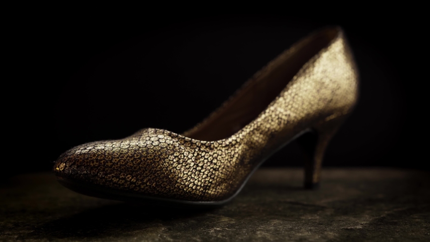 Golden high heel shoe UHD stock footage.