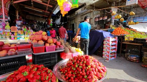 Unidentified people at a market in Gaza City, West Bank, the largest city of the State of Palestine, circa August 2021