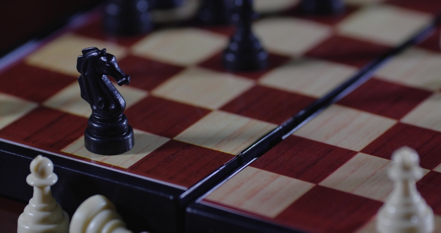 Chessboard extreme close-up. Two unrecognizable persons in white cloth gloves play chess, move pieces and make moves. The chess knight makes a move Royalty-Free Stock Footage #1079405615