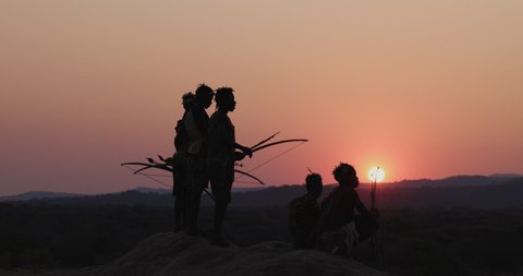Group of Hadza hunter-gatherer tribesmen out hunting at sunset Tanzania