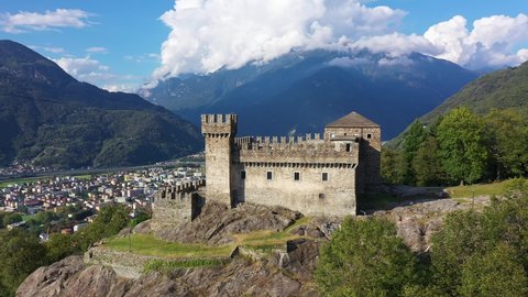 Aerial drone footage of the Sasso Corbaro castle overlooking the Bellinzona city in canton Ticino in Switzerland. Shot with a rotation motion. 