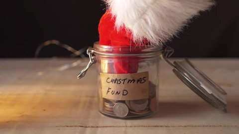 Santa takes money out of Christmas savings medium slow motion shot