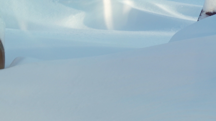 The ground is covered with a thick layer of snow. A lot of snow fell on the streets. Weather anomalies, falling snow.