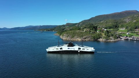 Hjelmeland , Rogaland , Norway - 08 26 2021: Modern ship Hydra crossing sea from Hjelmeland - Groundbreaking new technology with zero emission - liquid Hydrogen - Sunny day aerial view of ship from No