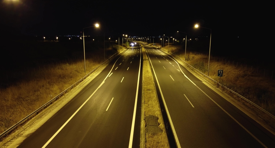 lights of cars passing by highway at night 