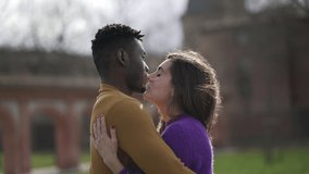 Interracial couple kissing and hugging each other outside. Black man and white girl embrace and love - Powered by Shutterstock - Get 15% off with code: PIKWIZARD15