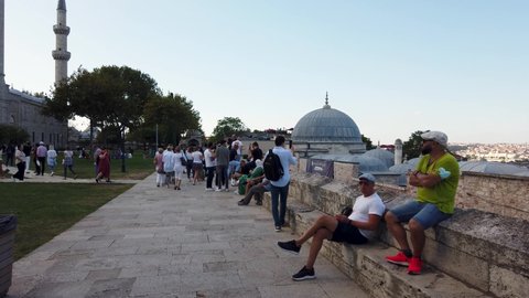 Istanbul, Turkey - September 2021: People watching Istanbul skyline from Suleymaniye Mosque park. Suleymaniye Mosque is a popular touristic spot of Istanbul