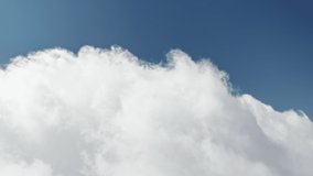 Birds eye view of white clouds flowing on blue sky on sunny day. Scenic shot of natural cloud formation moving in air. Fluffy clouds in sky. Environment concept with copy space, 4k footage