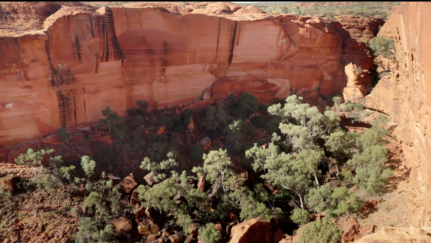 panning shot of cliffs as viewed from the rim of kings canyon in watarrka national park of the northern territory, australia