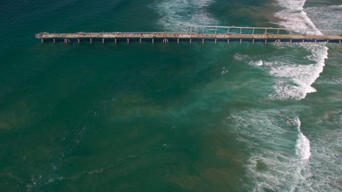 Aerial top down view showing ocean current in clear water over the popular seaway lookout The Spit Gold Coast QLD Australia