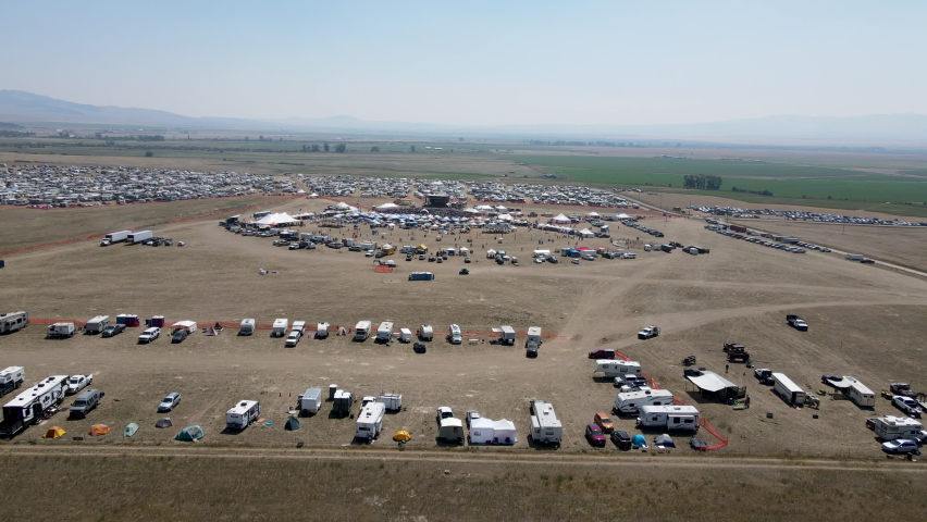 Large country music festival with fans and a large camping area for RV