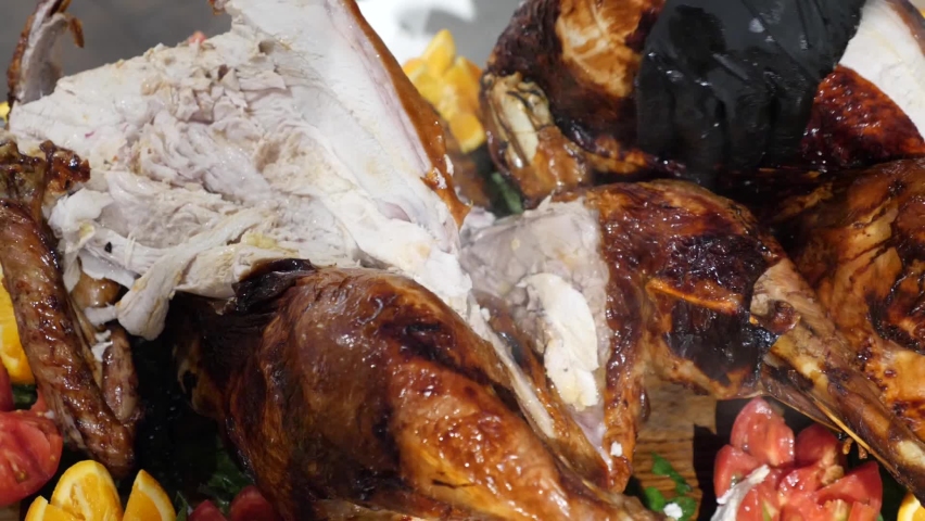The chef cuts slices of still hot turkey. An original turkey dish for the holidays. Thanksgiving day Royalty-Free Stock Footage #1079451029