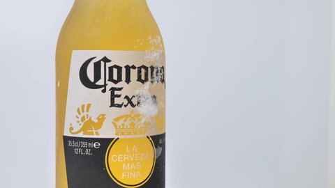 Rome Italy, July 16. 2021. A bottle of Corona Extra beer with lime on a white background, which, along with most of the beer sold worldwide, is pale-lager, produced by Cerveceria Modelo in Mexico