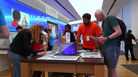 LONDON, UK- AUGUST 29, 2019. People and Family experience Microsoft products digital tablet, Microsoft Store on Oxford Circus, London UK