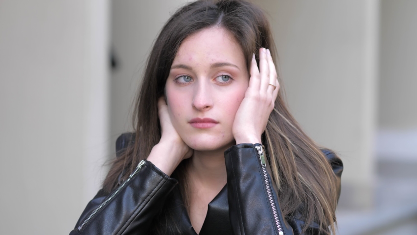 beautiful face of young sad woman looking away thinking