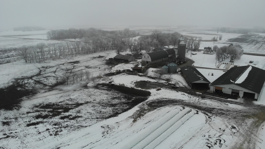 Drone shot of farm house in the winter with snow