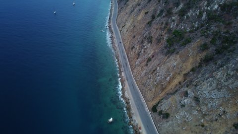 Aerial View High up as Car Drives Along Santa Catalina Coastal Highway Road, California, Reveal Shot