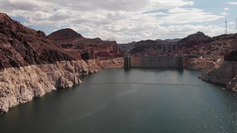 Drone shoting into the Hoover Dam during the day over Lake Powell