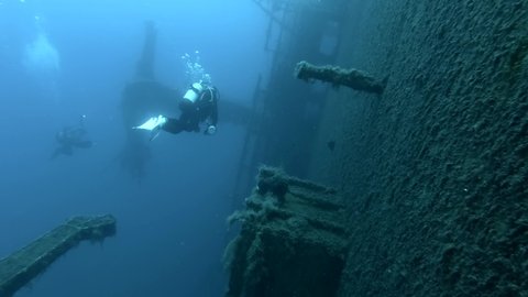 Scuba divers swims on the Shipwreck Swedish ferry MS Zenobia. Wreck diving. Mediterranean sea, Cyprus