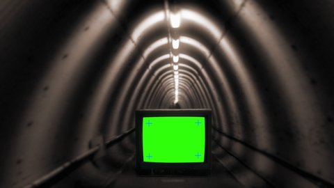 Zoom In TV Green Screen Crossing Underground Tunnel, Vintage Television. Walking through a dark tunnel with a green screen TV on the ground. Retro technology